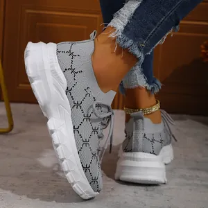 Macro view of women's grey breathable knit platform sneakers with thick white sole