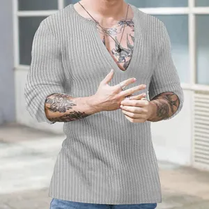 Detailed view of a grey slim fit knit shirt featuring a deep V-neck and ribbed texture