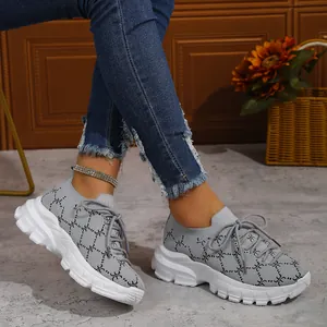 Detail view of grey knit platform sneakers with pattern and white chunky sole