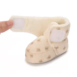Detailed view of soft fleece lining and cute teddy bear pattern on warm baby winter boots