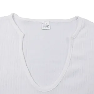 Close-up of V-neck collar and fabric label on white knit long sleeve T-shirt.