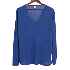Detail shot of the texture on a men's blue ribbed knit V-neck long-sleeved shirt