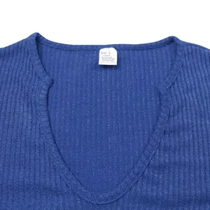 Detailed view of blue ribbed v-neck sweater neckline featuring the material and size tag.