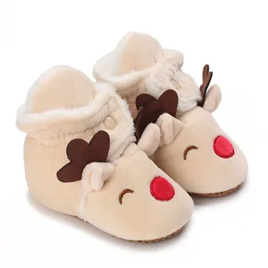 Macro view of cute reindeer plush baby winter snow boots with warm soft fleece lining