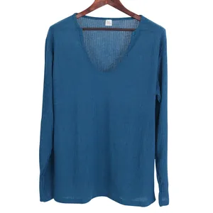 Thin v-neck men's long-sleeve knitted t-shirt in blue hanging on a wooden hanger