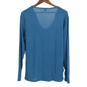 Close-up detail of the V-neckline and ribbed texture of a blue knit long-sleeve T-shirt.