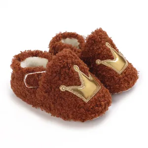 Comfortable brown plush newborn shoes with golden crown motif and soft warm lining