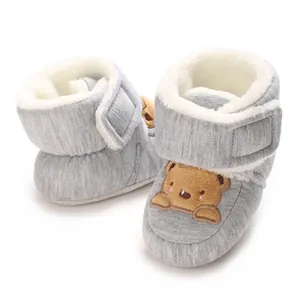 Close-up of grey infant fleece-lined boots with cute brown bear cartoon embroidery detail.