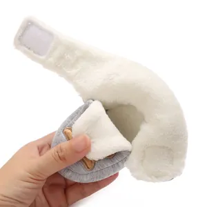 Detail view of baby walking shoe showing warm white fleece lining and velcro strap
