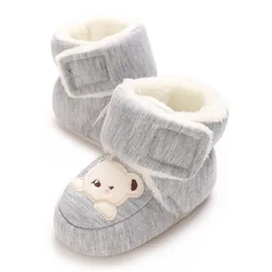 Close-up of baby winter walking shoes with warm fleece lining and cute bear design
