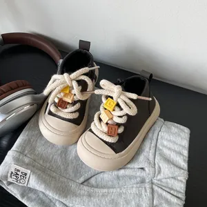 Detailed view of coffee brown toddler walking shoes with colorful alphabet beads