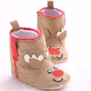 Detailed macro shot of cute brown reindeer baby boots with red trim for Christmas