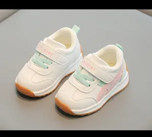 Dettaglio ravvicinato di sneakers bianche per bambini con accenti rosa e verde menta