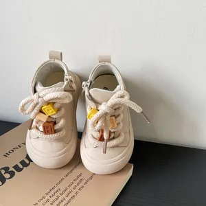 High-quality beige toddler sneakers with thick cotton laces and colorful letter block charms