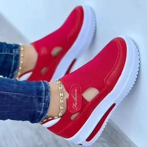 Close-up detail of red breathable fly-knit sneakers with thick white soles and hollow design