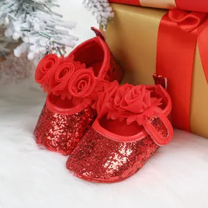 Detailed view of red glitter baby shoes featuring elegant rose floral decorations