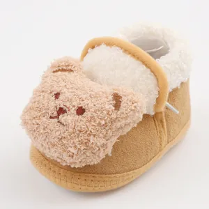 Close-up detail of warm baby pre-walker shoe with a cute 3D plush bear head and soft fleece lining