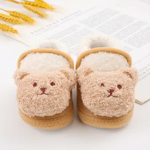 Detailed view of cute plush teddy bear baby slippers with soft warm white fleece lining