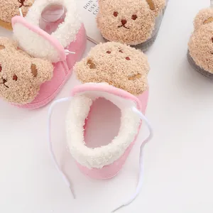 Close-up of cute cartoon bear baby shoes featuring soft faux shearling lining and warm design