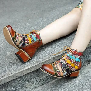 Handmade vintage patchwork leather ankle boots with colorful ethnic pattern on steps