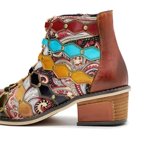 Detailed view of retro colorful patchwork leather ankle boots with paisley patterns