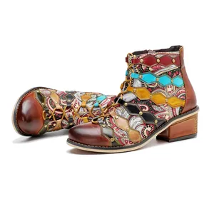 Detailed view of handmade bohemian patchwork leather ankle boots with paisley patterns