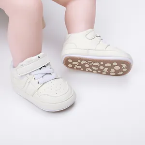 Cream white baby walker shoes with rubber soles and velcro straps for infants.
