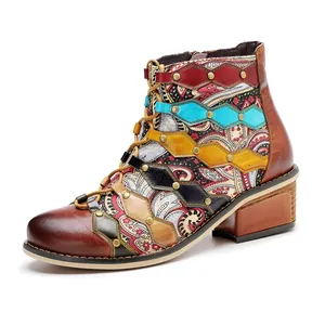 Close-up detail of retro handmade leather patchwork ankle boots with paisley patterns
