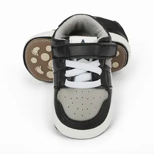 Detailed view of baby indoor walking shoes with non-slip rubber soles in black and grey