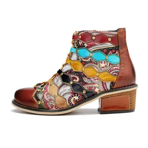 Side view detail of vintage patchwork leather ankle boots with paisley print and studs