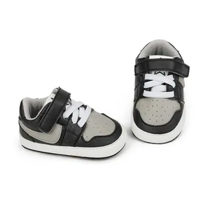 Detailed view of black and grey baby walking shoes with rubber sole and velcro strap