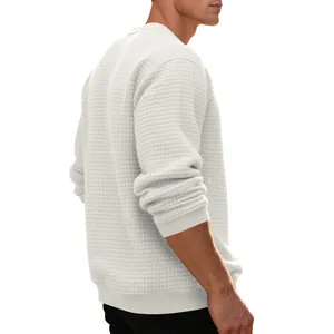Close-up view of a men's off-white long-sleeve sweatshirt with waffle jacquard texture