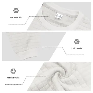 Close-up of fabric texture, neck and cuff details of a white jacquard grid sweatshirt