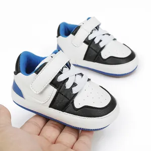 Detailed close-up view of blue and black baby walking shoes with a soft rubber sole
