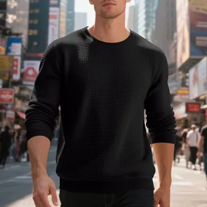 Detailed view of the waffle knit texture on a black men's crewneck sweatshirt.