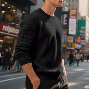 Detail view of men's black crewneck sweatshirt with waffle knit texture and loose fit