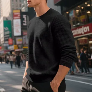 Macro view of black waffle knit texture on men's long sleeve crewneck sweater