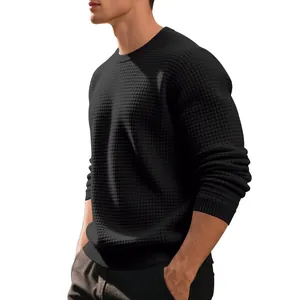 Detail shot of black waffle knit crewneck sweater for men, focus on textured pattern.