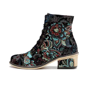 Detailed side view of vintage floral embroidered lace-up boots with Chinese patterns