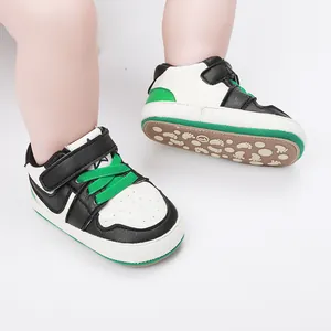Detailed macro view of casual infant walking shoes with green accents and soft soles