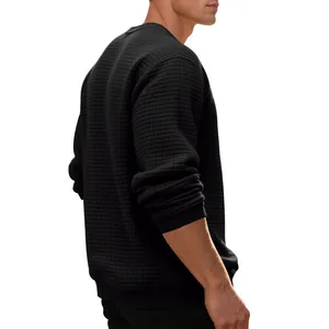 Detailed macro view of the black waffle jacquard texture on men's sweatshirt