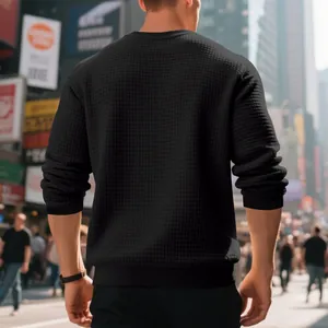 Rear view detail of black men's waffle knit crewneck sweatshirt in urban setting