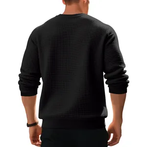 Detail view from the back of a men's black relaxed fit waffle texture sweatshirt