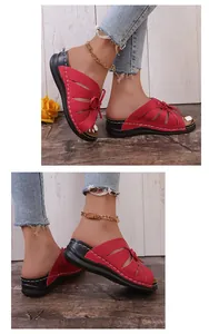 Detailed close-up view of women's red wedge sandals featuring a bow and cutouts