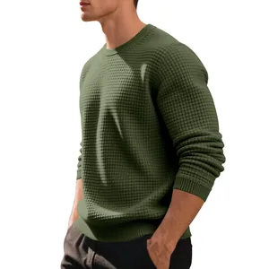 Detail of men's olive green waffle knit sweater with crew neck and ribbed cuffs.