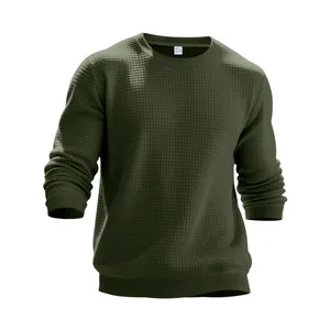 Detailed view of dark green mens waffle knit crewneck sweatshirt with ribbed cuffs.
