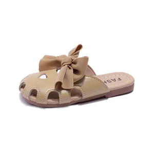 Charming beige children's bow slippers with closed-toe hollow heart design