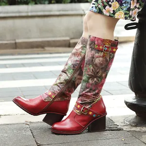 Vue détaillée de bottes en cuir rouge faites main avec imprimé fleuri et talons blocs