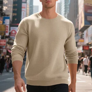 Close-up of men's beige waffle-knit crew neck sweatshirt in an urban street setting