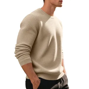 Detailed view of men's beige waffle knit crewneck sweater with textured square pattern